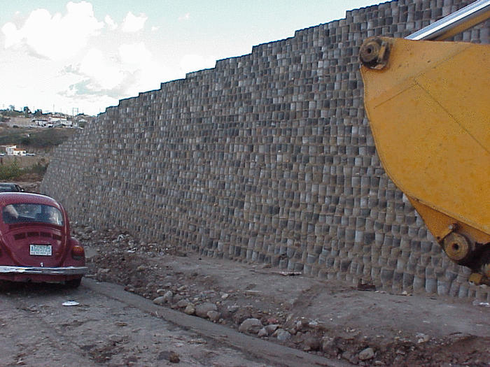 Side view of retaining wall built with discarded tires.